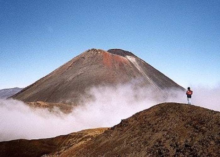 Mt. Ngauruhoe with clouds and hikers from above Red Crater on the the Tongariro Crossing
