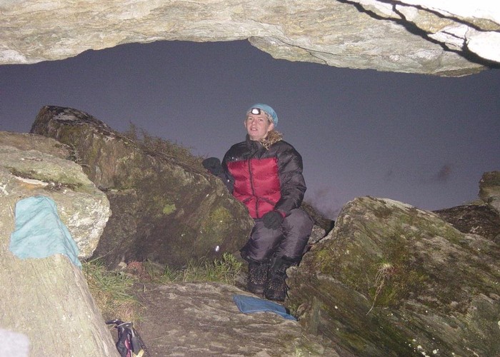 Kathryn sits at the opening of the rock bivvy on the Olivine ledge.